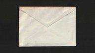 A cream envelope on a black background