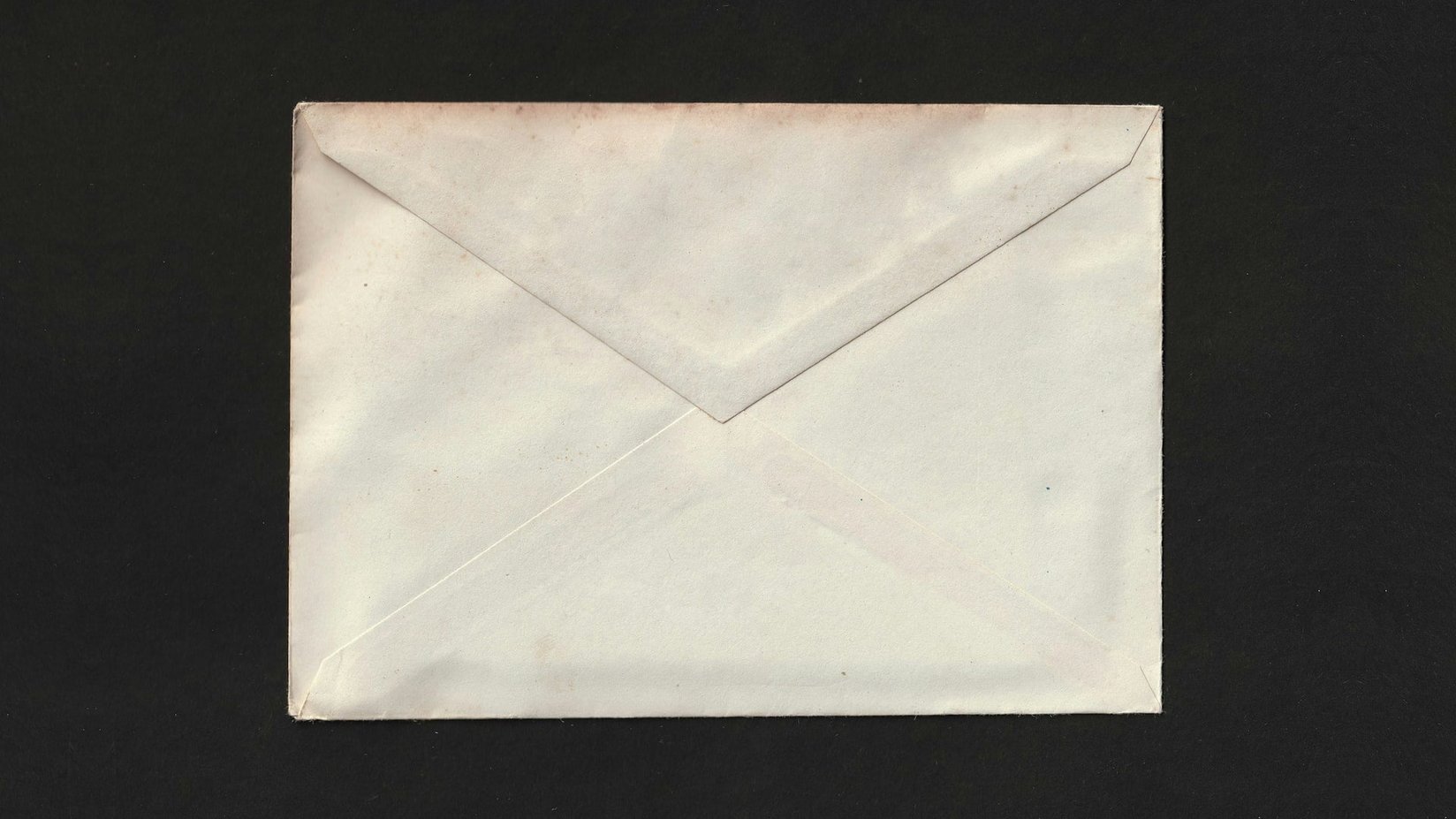 A cream envelope on a black background