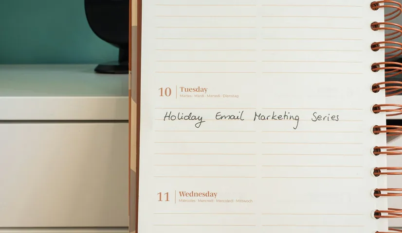 A planner page with a holiday email marketing series written on it