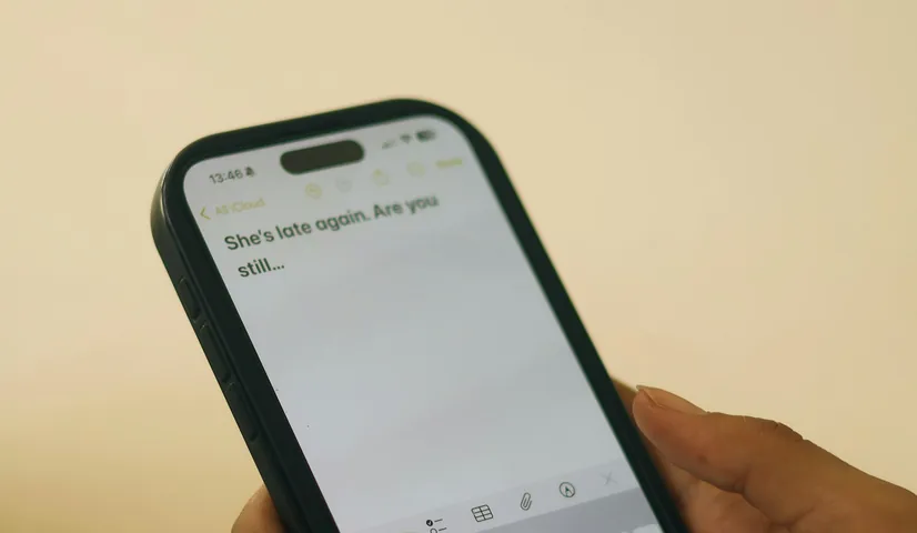 Hands typing a text message on a smartphone